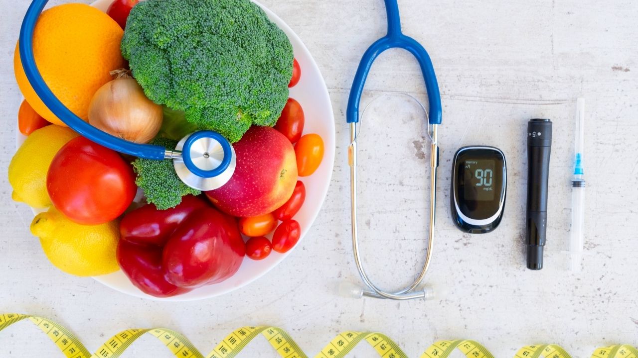Fresh fruit beside a stethoscope and blood glucose monitor — Diabetes awareness.