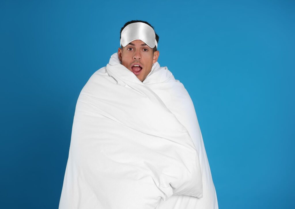 man wrapped in a duvet before bed