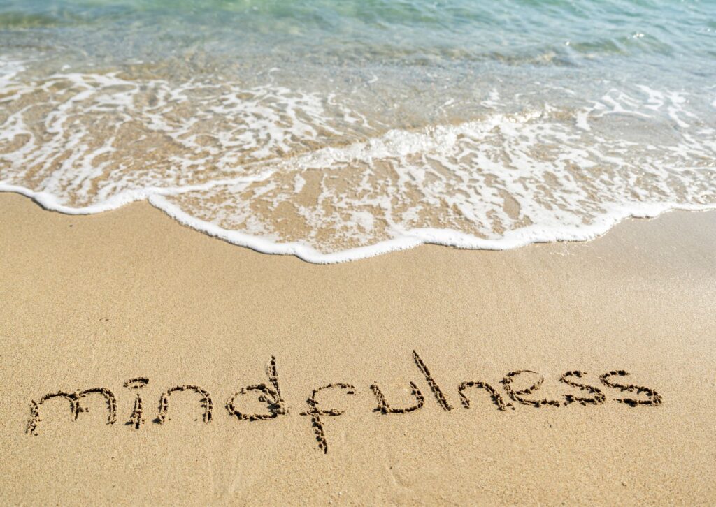 mindfulness written in the sand