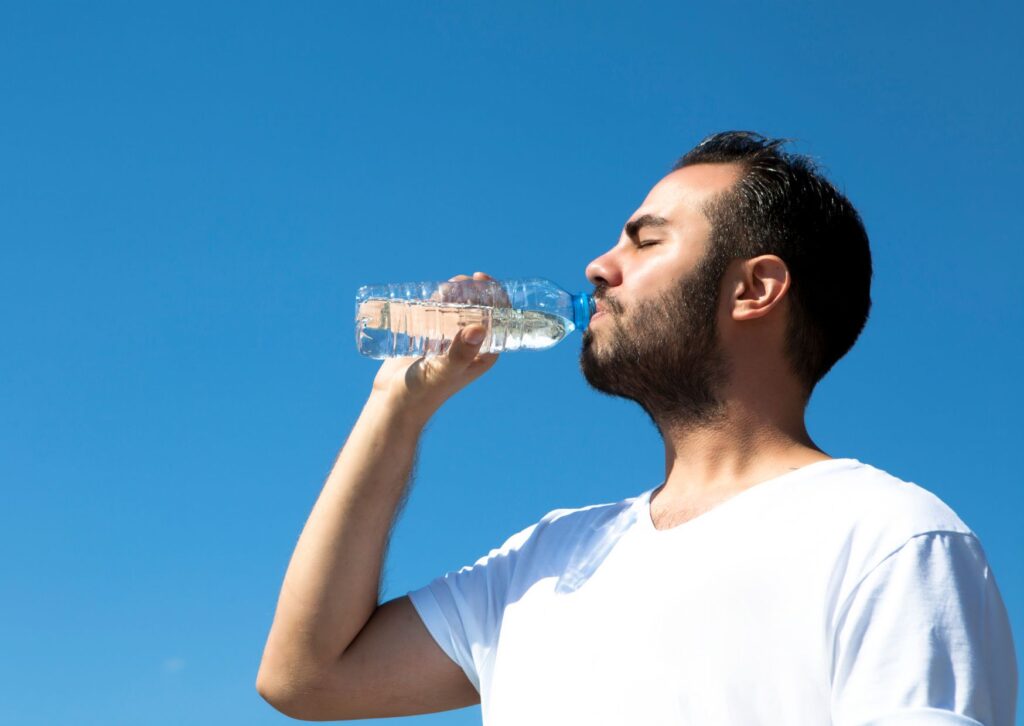 Man drinking water in the sun