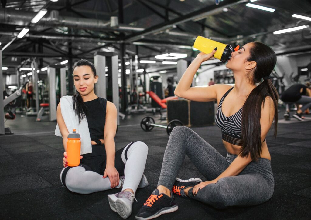 Women drinking water at the gym
