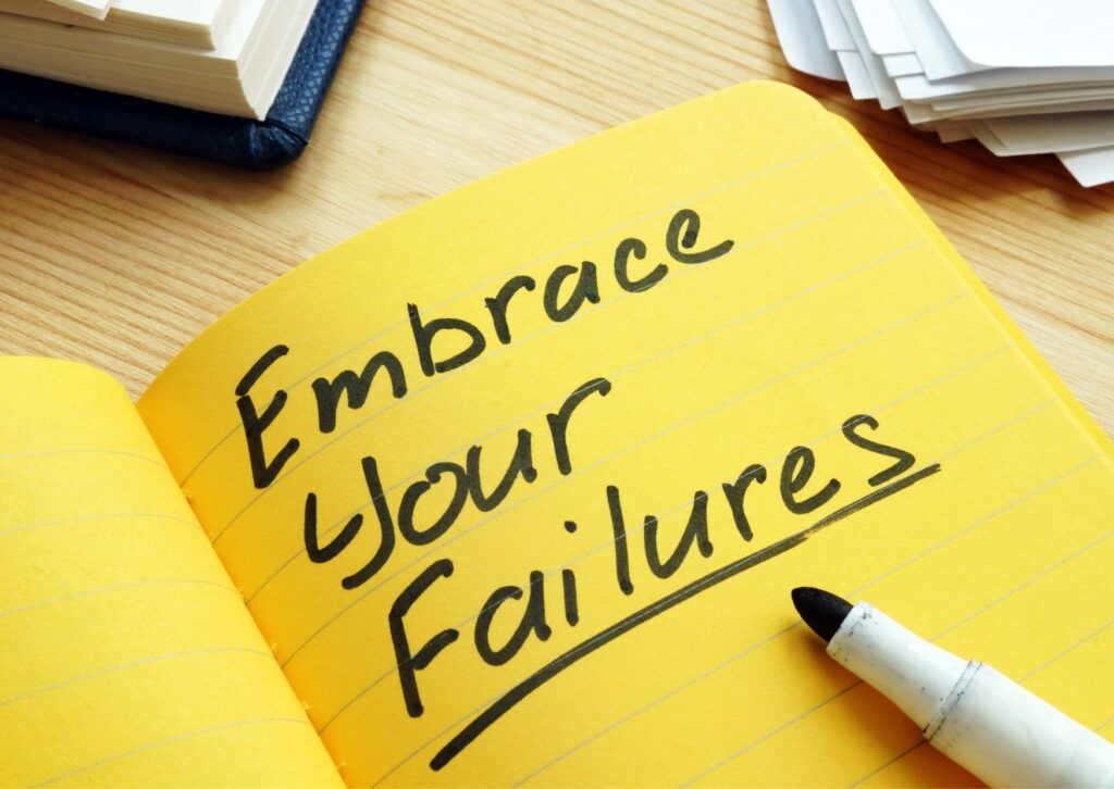 embrace your failure written on a notepad