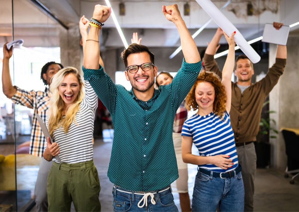 happy-employees-raising-their-arms-and-smiling