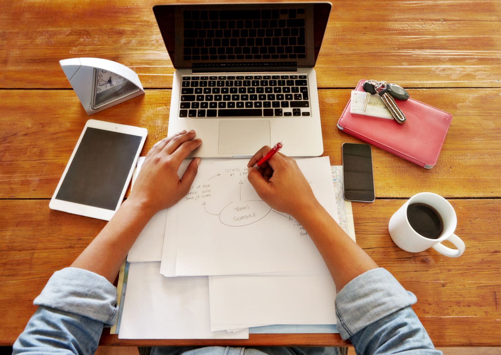 Professional taking notes during a live productivity webinar.
