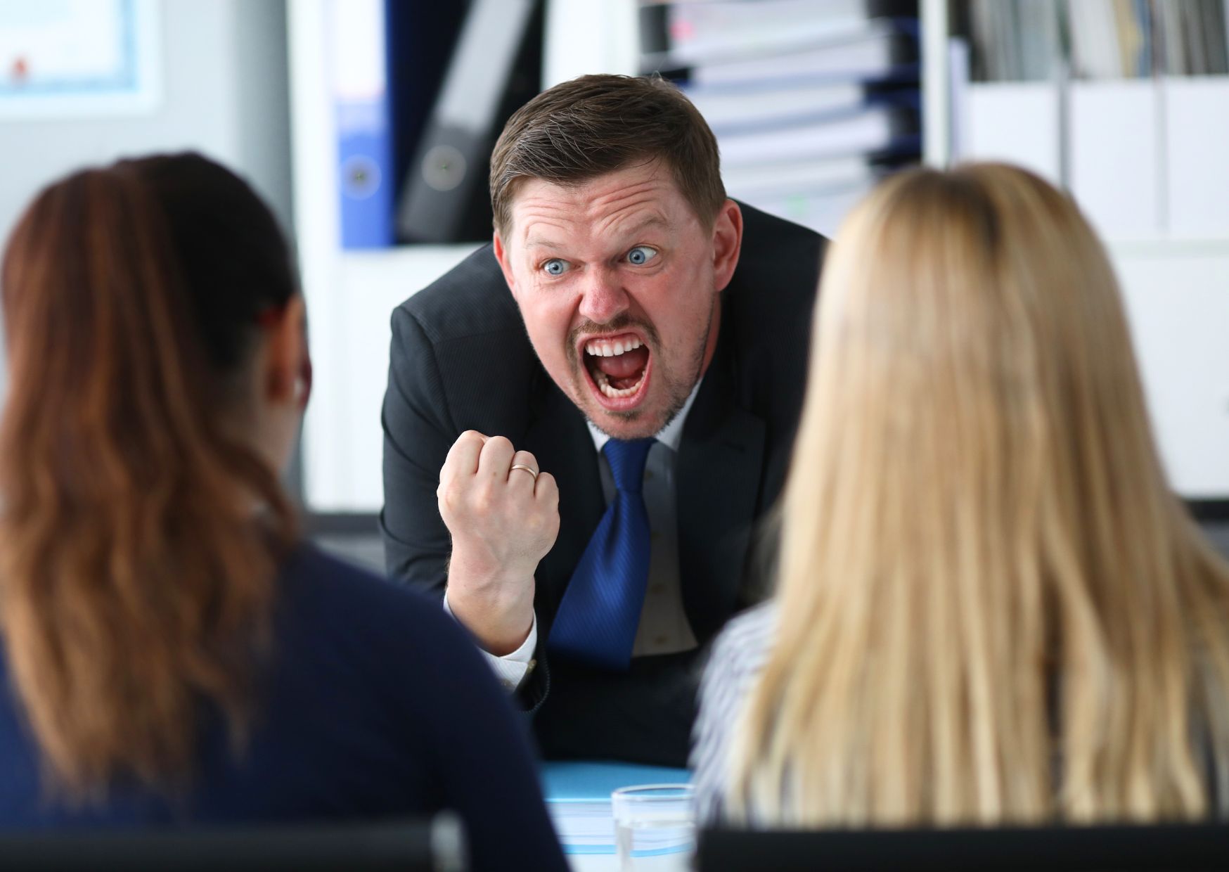 disrespectful-male-employee-shouting-at-colleagues
