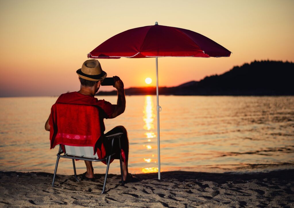 man-relaxing-at-the-beach-with-the-sunset