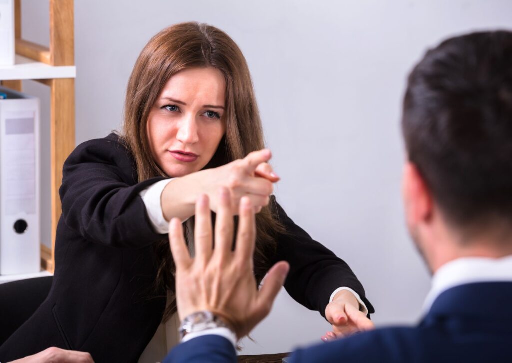 woman-pointing-in-a-rude-and-disrespectful-way-to-male-colleague