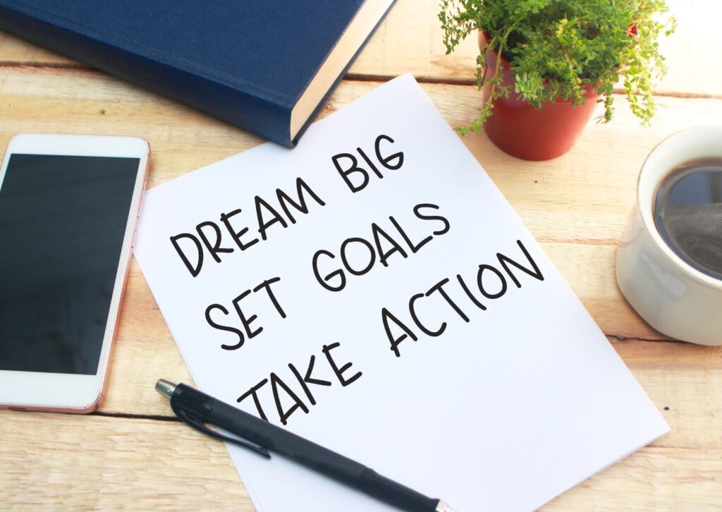 dream-big-set-goals-take-action-written-on-a-piece-of-paper