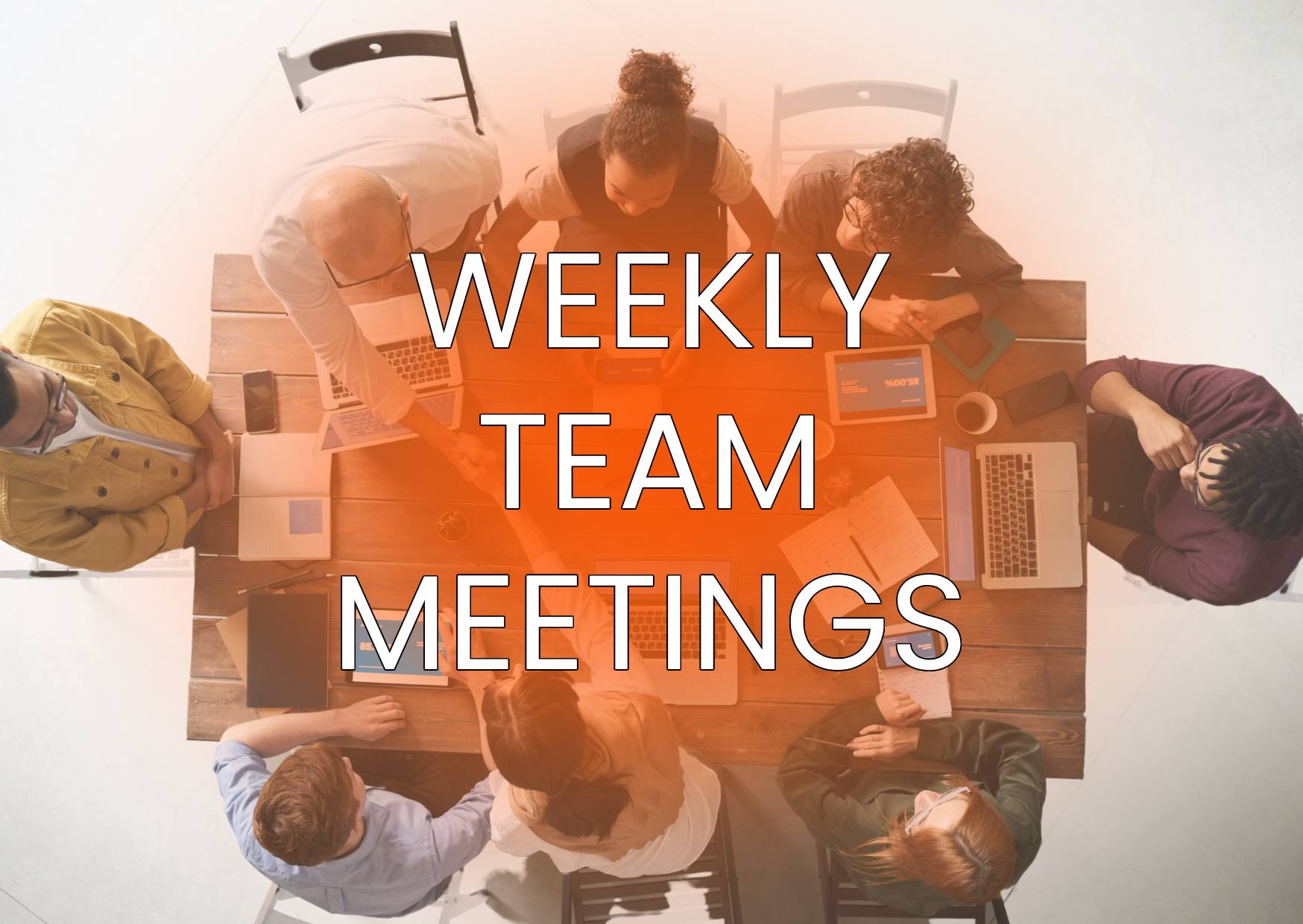 WEEKLY-TEAM-MEETINGS-WRITTEN-INFRONT-OF-EMPLOYEES-HAVING-A-TEAM-MEETING