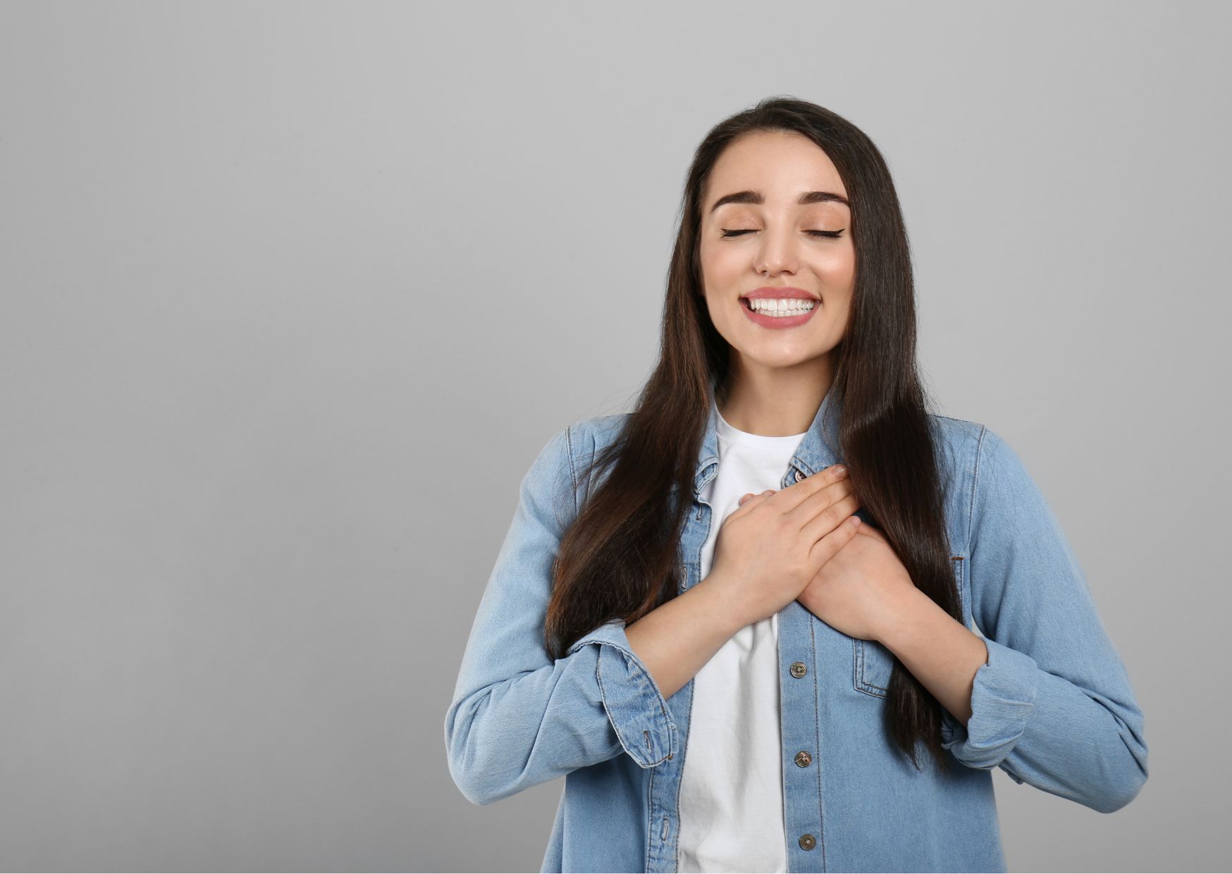 Person with hand on chest practicing gratitude—calm, reflective moment.