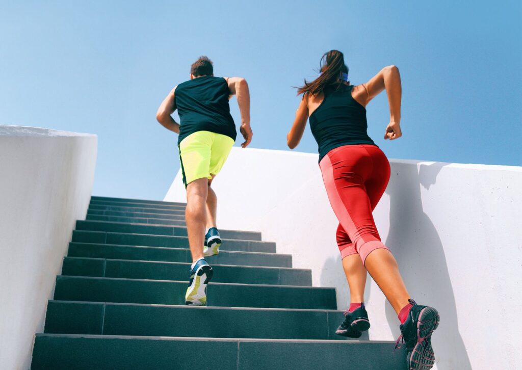 man-and-woman-running-up-stairs