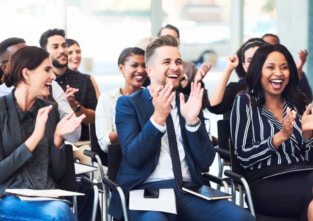 Staff clapping at a company conference