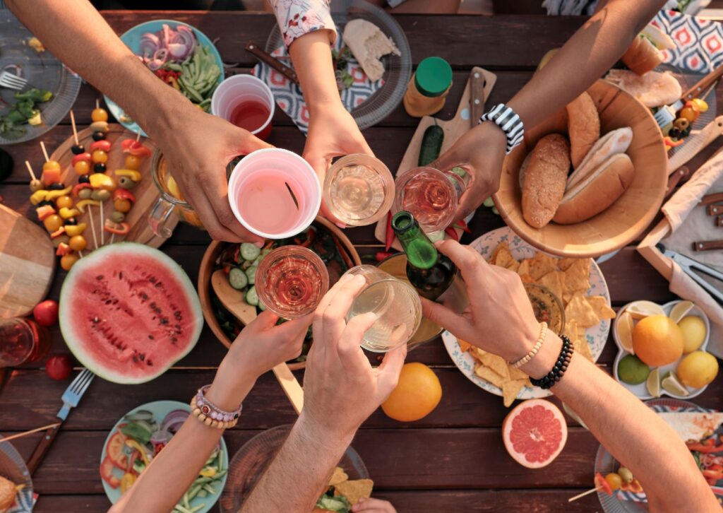 settings-of-a-picnic-with-lots-of-food-and-hands-in-the-photo