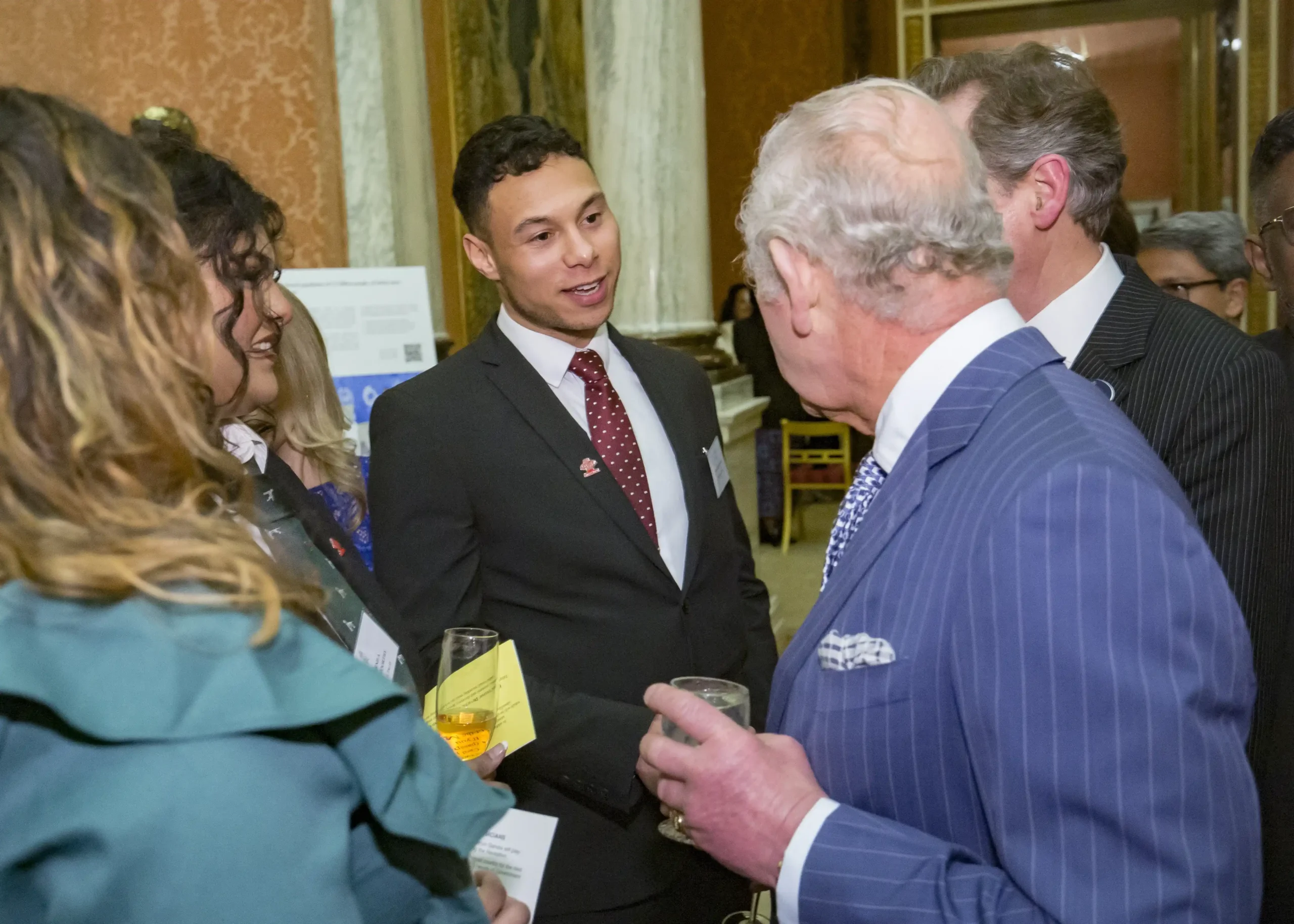Loving Life founder Tyler Lowe greeting King Charles at Buckingham Palace
