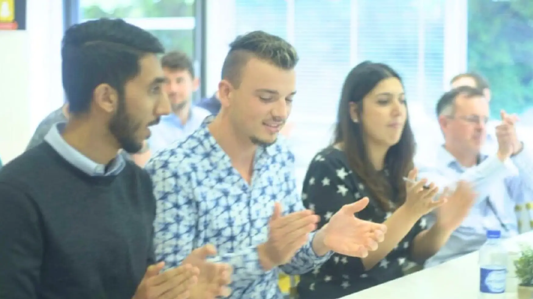 Leaders applauding following an online webinar.
