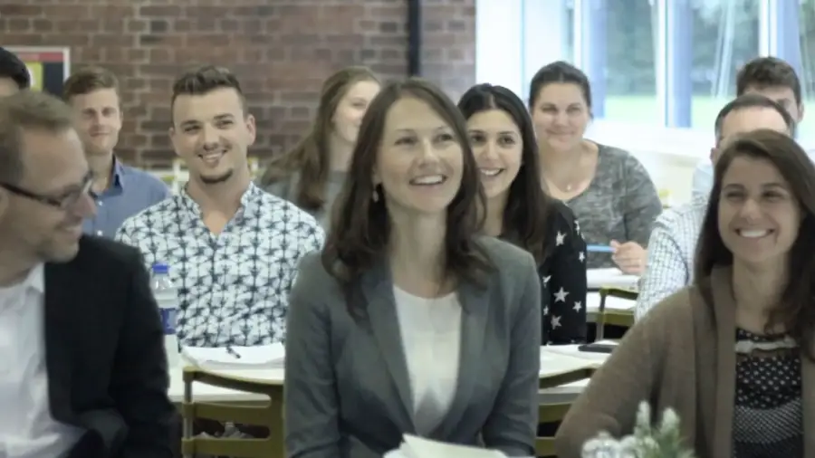 Happy employees engaged in a workplace wellbeing workshop.
